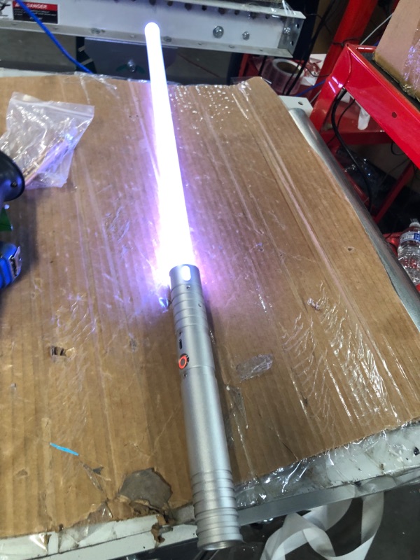 Photo 2 of Kiseely Lightsaber, 15 Colors Light Sabers with Vibrating Metal Hilts, 2 in 1 LED Light Sword with 3 Sounds Mode, Metal Hilts | Light Burst Mode | Rechargeable Battery (Silver)