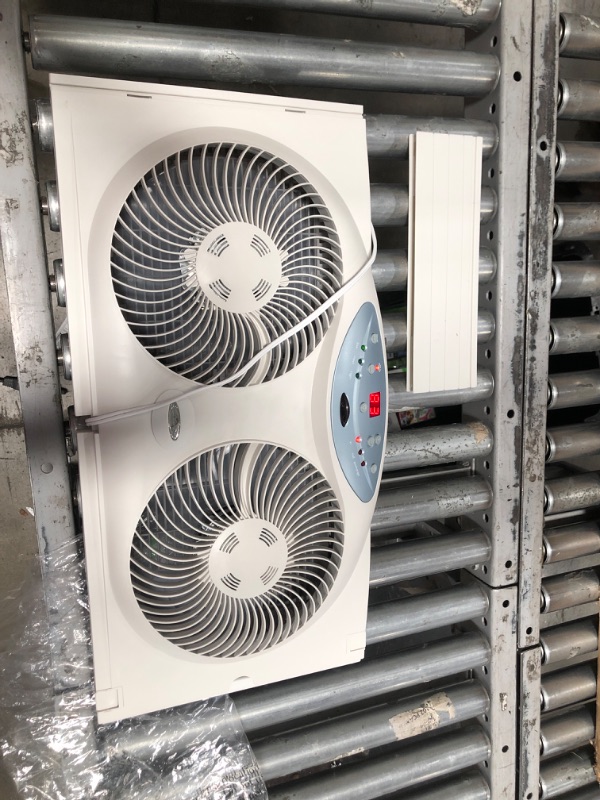 Photo 2 of **MINOR DAMAGE** Bionaire Window Fan with Twin 8.5-Inch Reversible Airflow Blades and Remote Control, White
