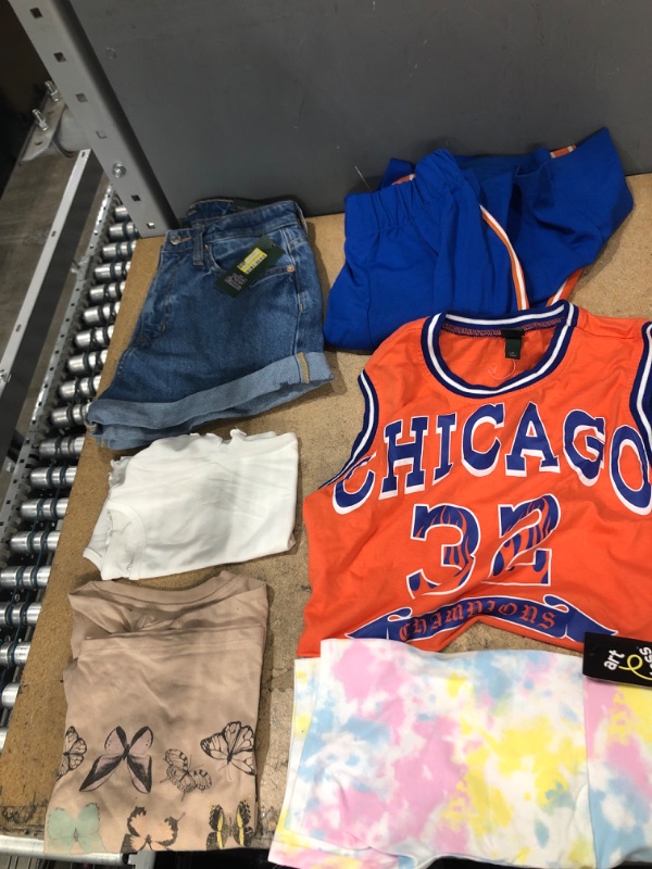 Photo 1 of  Clothing Bundle Sizes: X-small, and one Size 0 *** 5 Items*** One set of orange/blue shirt and pant, 2 shorts, 2 white and beige kid shirts