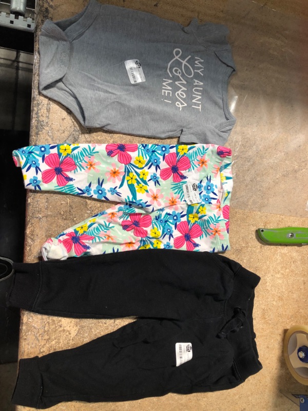 Photo 1 of bundle of 3 baby girl clothes 
onesi 0-3m, floral pants 18m and black sweats 18m 