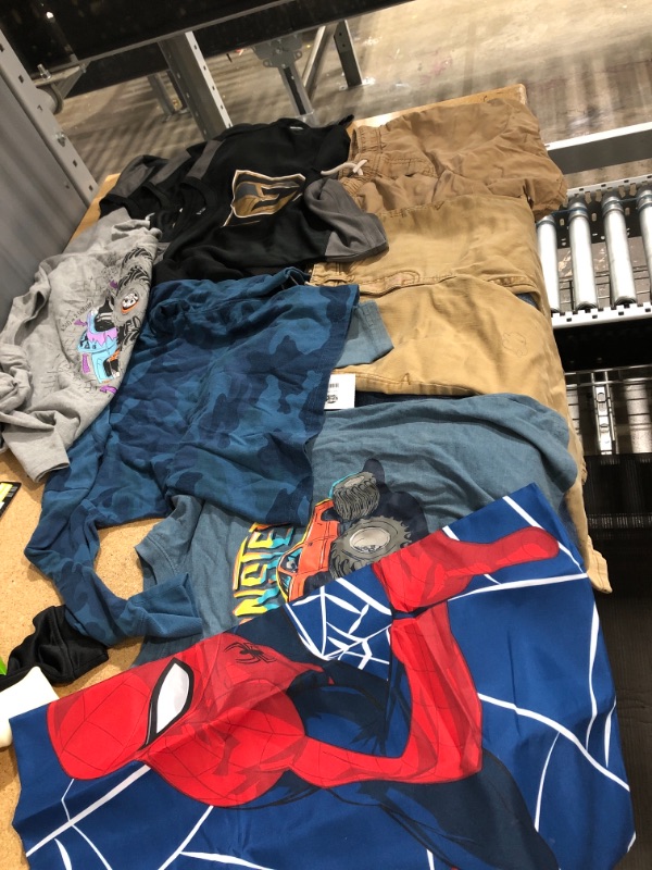 Photo 1 of assorted boys clothes bundle- assorted sizes, pants all size 7, spiderman flag- 8 items 