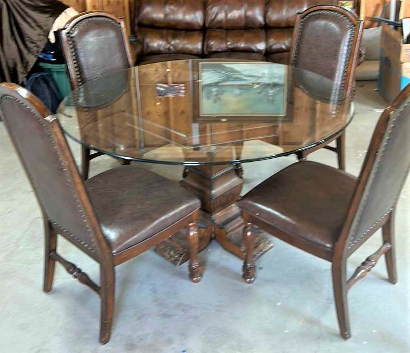 Photo 1 of WOOD GLASS TOP ROUND PEDESTAL TABLE W FOUR LEATHER AND WOOD CHAIRS 5’ x H 30”