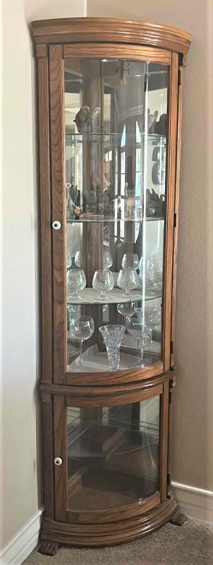 Photo 1 of LIGHTED WOOD CORNER CURIO CABINET (CONTENTS SOLD SEPARATELY) 25” x 17” x H 76”
