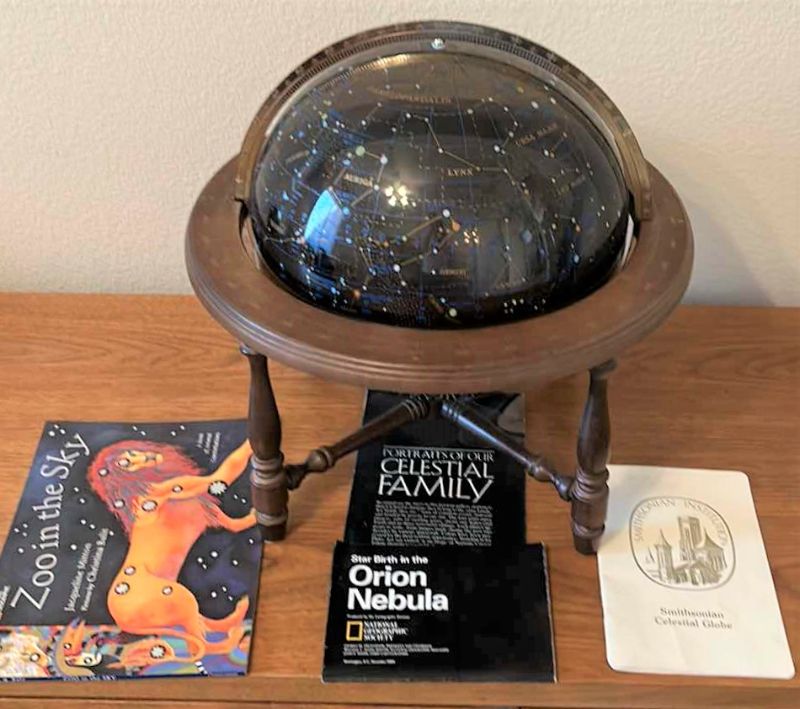 Photo 1 of Glass celestial globe with pamphlets and "Zoo in the sky' book  (globe with base measures 17” x 17”)