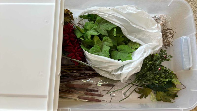 Photo 1 of 2 - under the bed storage totes, one with floral pieces