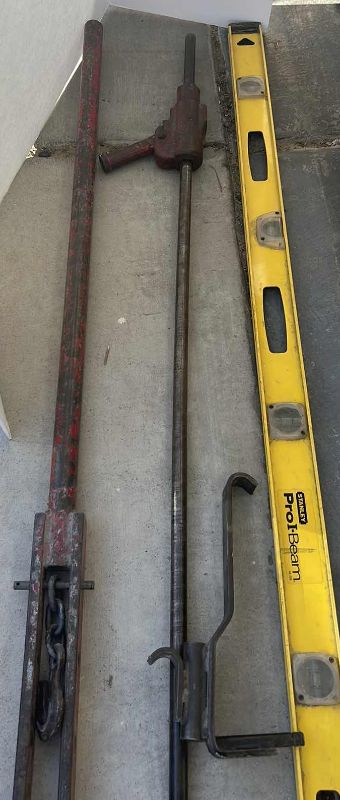 Photo 1 of THREE VERY LARGE METAL TOOLS, PUSH PULL, JACK 56" AND 6’ LEVEL