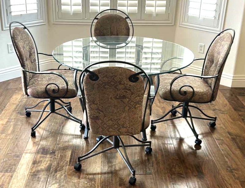 Photo 1 of WROUGHT IRON ROUND DINING ROOM TABLE W GLASS TOP AND 4 CHAIRS ON WHEELS  48” ROUND H28.5”