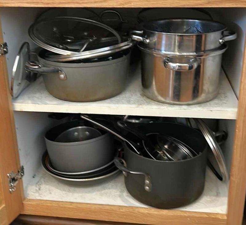 Photo 1 of CONTENTS OF KITCHEN CABINET-.POTS PANS AND MORE