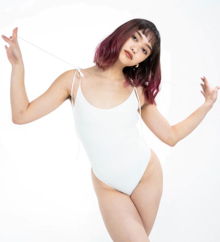 Photo 3 of SIZE X-SMALL WHITE AURA BODYSUIT FEATURES ROUND NECKLINE W EXTENDED STRAPS THAT TIE AND HIGH CUT LEGS, ULTRA SOFT COTTON LINING FOR COMFORT. CAN WEAR AS SWIMWEAR