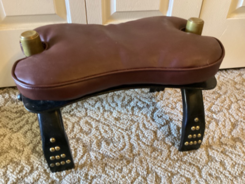 Photo 2 of VINTAGE CAMEL SADDLE FOOT STOOL WITH BRASS COVERED CAPS 19” X 11 X 14”