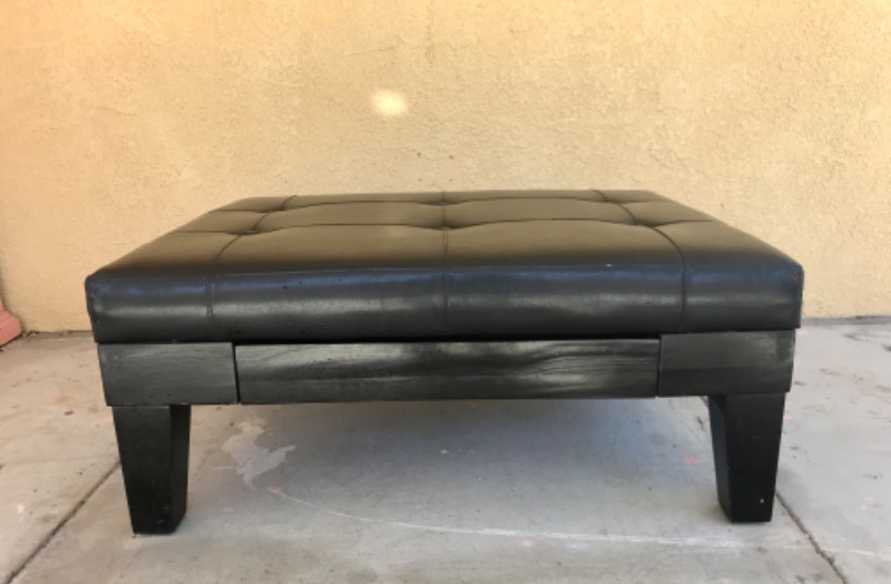 Photo 2 of BLACK LEATHER OTTOMAN W/ WOOD LEGS AND STORAGE DRAWER 40”x 30”x 17”