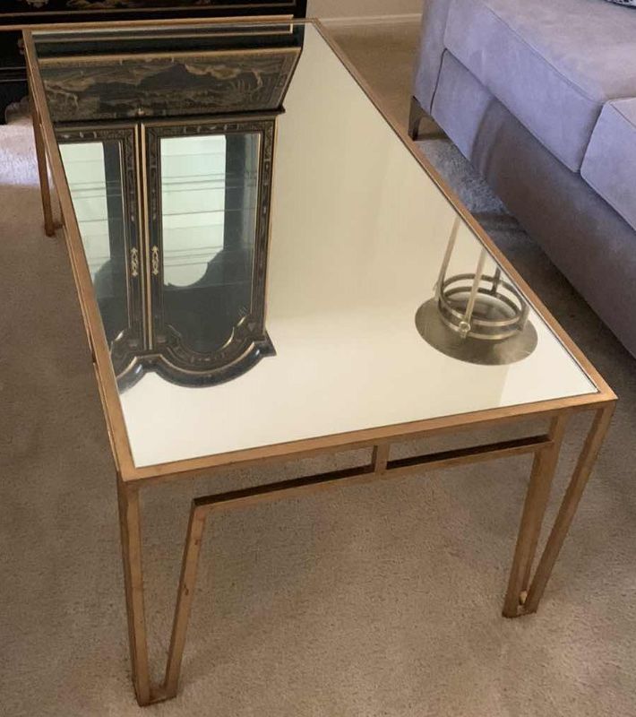 Photo 1 of BRASS AND GLASS COCKTAIL TABLE 24” X 48” H 18”
