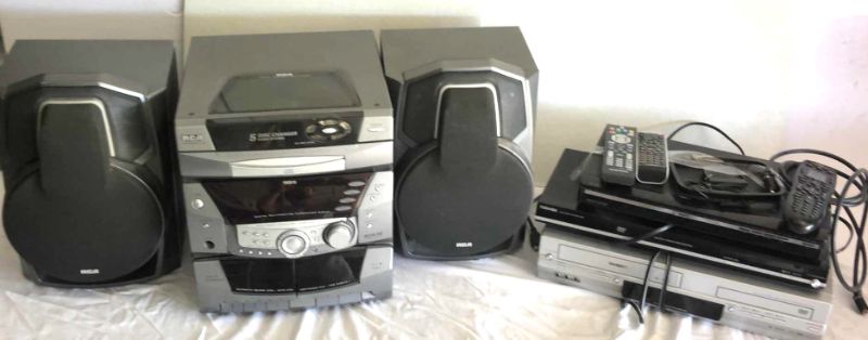 Photo 1 of ENTERTAINMENT BUNDLE RCA RS-255KM AUDIO SYSTEM, DVD AND VHS PLAYERS W REMOTES, STAR TREK VHS SETS