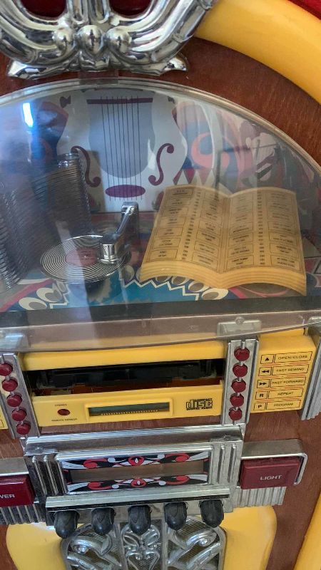 Photo 2 of ELECTRONIC JUKEBOX WITH RADIO AND DISC SLOT 22” X 11” H 39”