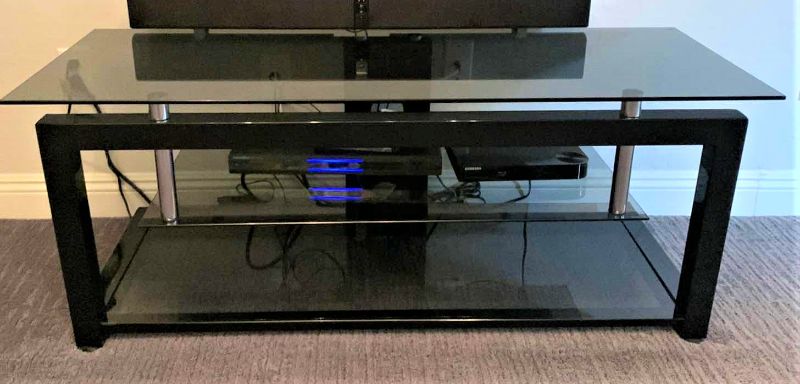 Photo 1 of BLACK TEMPERED SMOKED GLASS W CHROME ENTERTAINMENT CONSOLE (ELECTRONICS OR SOUNDBAR NOT INCLUDED) 52” x 20” x H20”