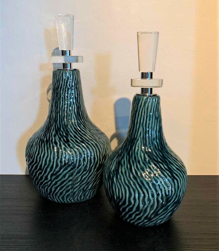 Photo 1 of 2- UTTERMOST ALMERA CERAMIC BOTTLES W DARK TEAL GLAZE POLISH NICKEL W THICK CRYSTAL DETAILS H15.5” & 13.5”