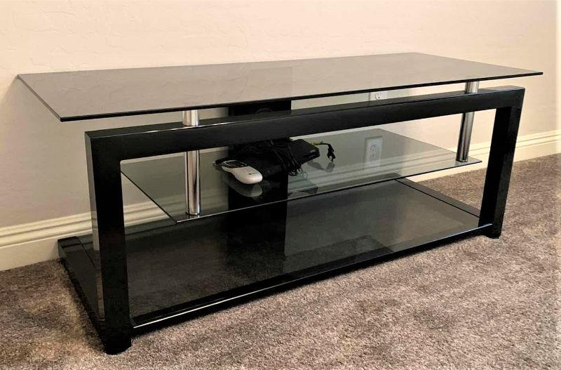 Photo 1 of BLACK SMOKED GLASS W CHROME ENTERTAINMENT CONSOLE (ELECTRONICS AND SOUND SYSTEMS NOT INCLUDED) 52” x 20” x H20”