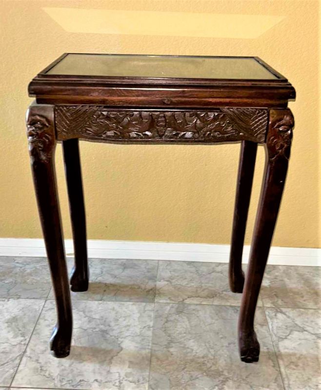 Photo 1 of CARVED WOOD TABLE WITH GLASS TOP, 19” x 12” H27”