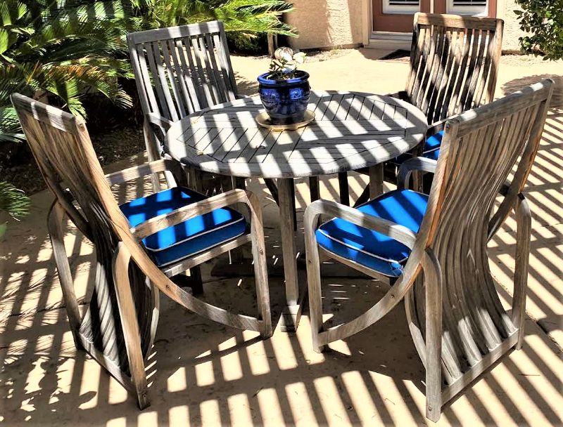 Photo 1 of TEAK WAREHOUSE DINING SET WITH 4 CHAIRS MARINE BLUE WATER REPELLANT AND SUN PROTECTION FABRIC AND POTTED PLANT - TABLE 43” H29” 