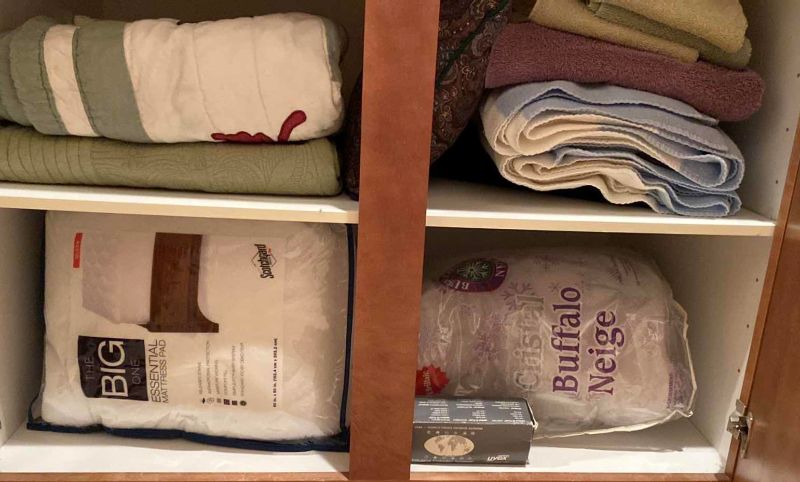 Photo 1 of Contents of 2 cabinets, quilts towels, linens