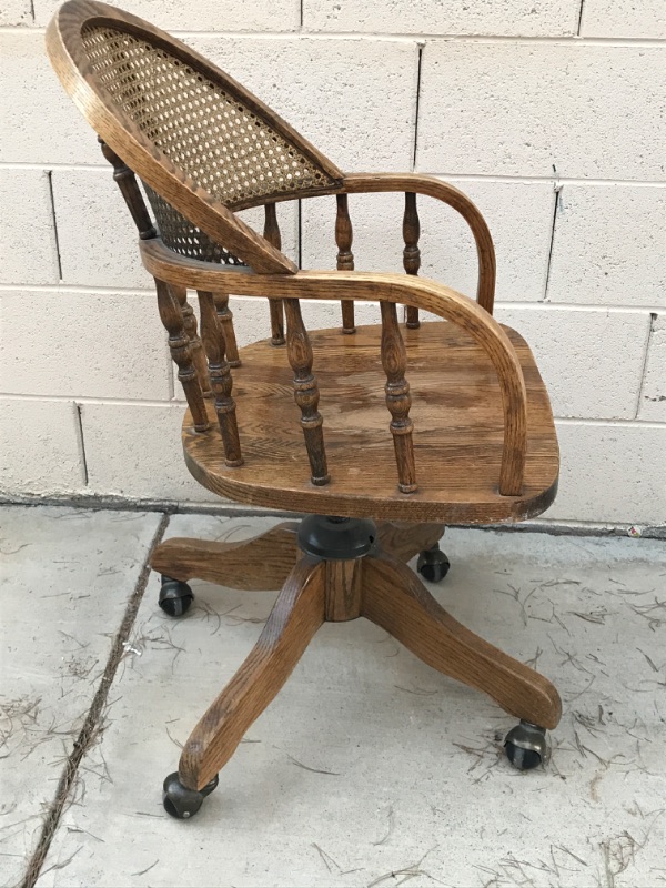 Photo 3 of ANTIQUE SOLID WOOD SWIVEL CHAIR WITH CURVED CANE BACK ON CASTERS