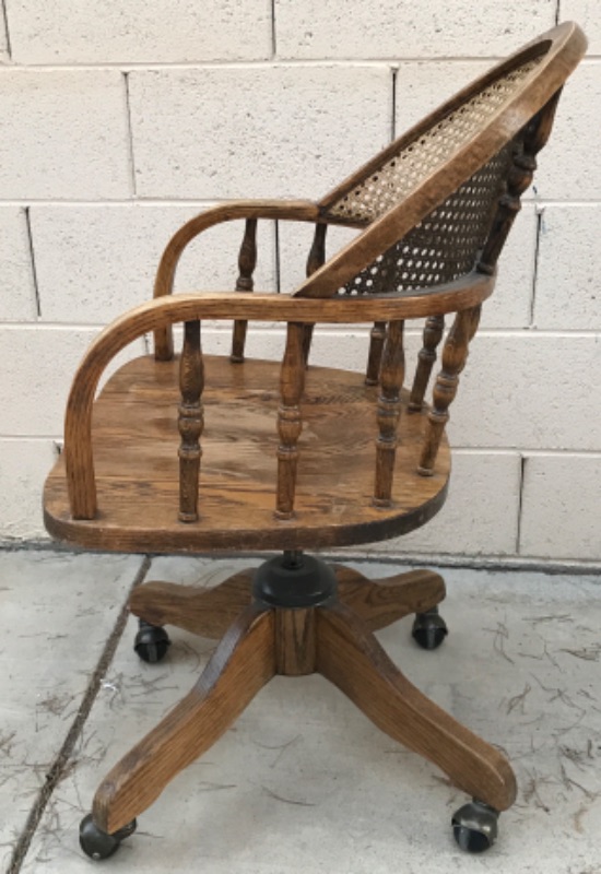 Photo 4 of ANTIQUE SOLID WOOD SWIVEL CHAIR WITH CURVED CANE BACK ON CASTERS