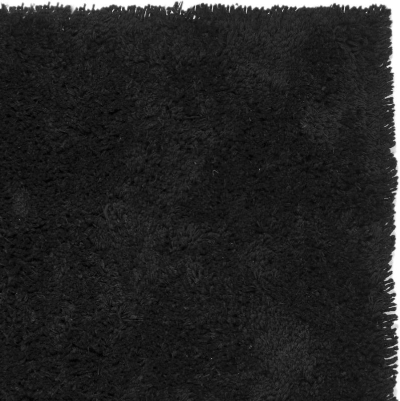 Photo 1 of Solid black area rug with polypropylene pile for a plush texture
Resists fading and stains; can be vacuumed or spot cleaned
Action backing requires a gripper to prevent accidental slipping