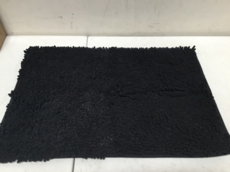 Photo 2 of Solid black area rug with polypropylene pile for a plush texture
Resists fading and stains; can be vacuumed or spot cleaned
Action backing requires a gripper to prevent accidental slipping