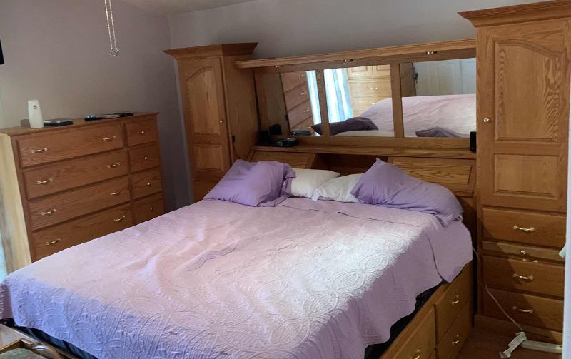 Photo 1 of CAL-KING CAPTAIN’S BED WITH LARGE MIRRORED HEADBOARD OAK, NOT COMPRESSED WOOD 10’8” X 8’3” H 6’ 9” MATRESS NOT INCLUDED