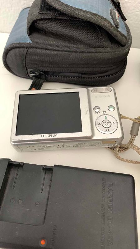 Photo 1 of FUJIFILM FINEPIX J10, BATTERY CHARGER AND A BELL HOWELL 985D CAMERAS