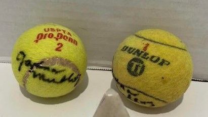 Photo 1 of TWO AUTOGRAPHED TENNIS BALLS