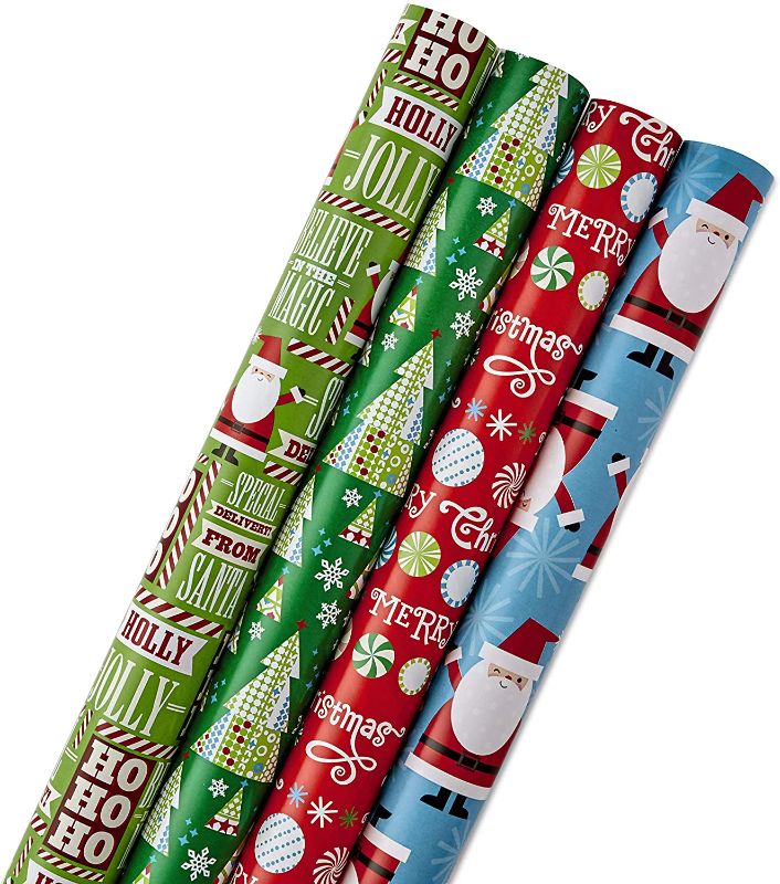 Photo 1 of **PACK OF 8** Hallmark Reversible Christmas Wrapping Paper Bundle for Kids (Pack of 4, 150 sq. ft. ttl.) Candy Canes, Santa, Trees, Red, Blue, Green