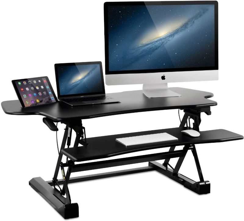 Photo 1 of Mount-It! Height Adjustable Standing Desk Converter | 48” Wide Tabletop Sit Stand Desk Riser with Gas Spring | Stand Up Computer Workstation Fits Dual Monitors | Black | MI-7925
- Missing//loose hardware 
