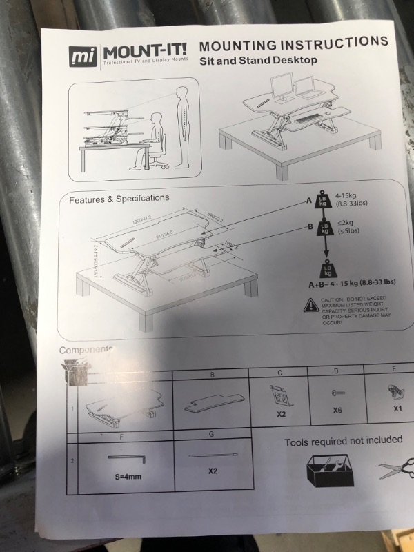 Photo 2 of Mount-It! Height Adjustable Standing Desk Converter | 48” Wide Tabletop Sit Stand Desk Riser with Gas Spring | Stand Up Computer Workstation Fits Dual Monitors | Black | MI-7925
- Missing//loose hardware 
