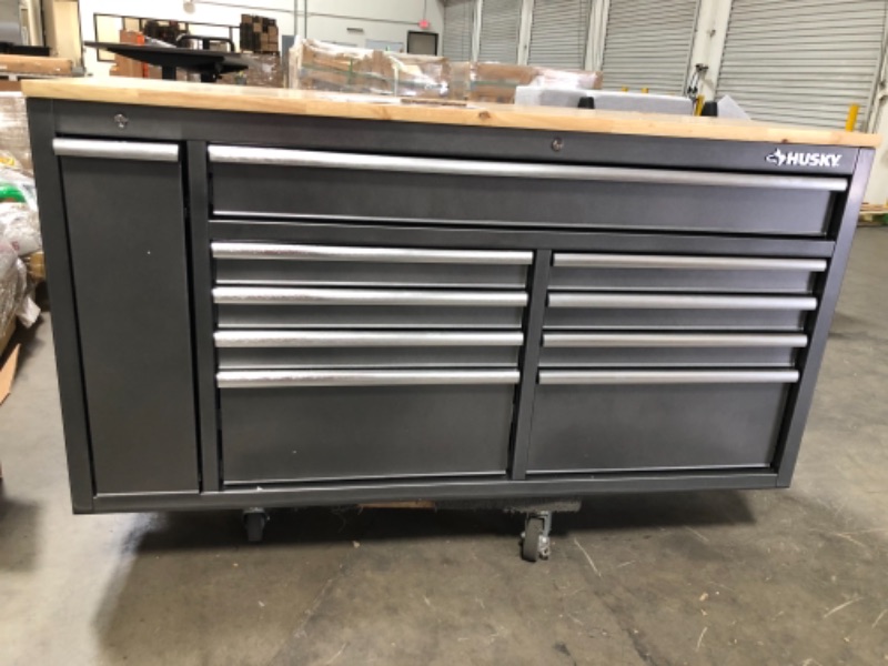 Photo 9 of *minor dents on side panel of chest , wooden top is loose**
Husky 61 in. W 10-Drawer, Deep Tool Chest Mobile Workbench in Metallic Silver with Sliding Vertical Bin Storage Drawer
