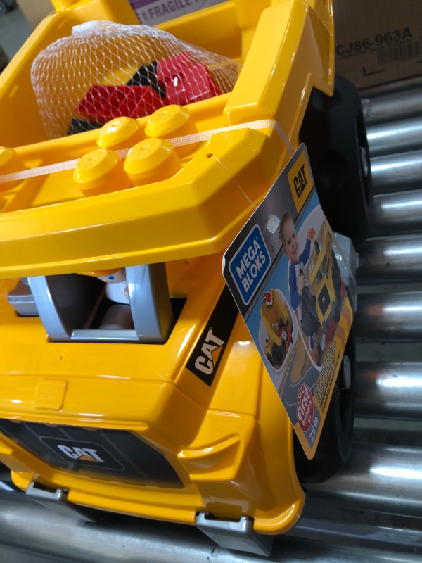 Photo 2 of Mega Bloks Cat Dump Truck - Moveable Bin That Tilts Back to Dump Out Blocks - Includes 1 Construction Worker Figurine and 25 Blocks
