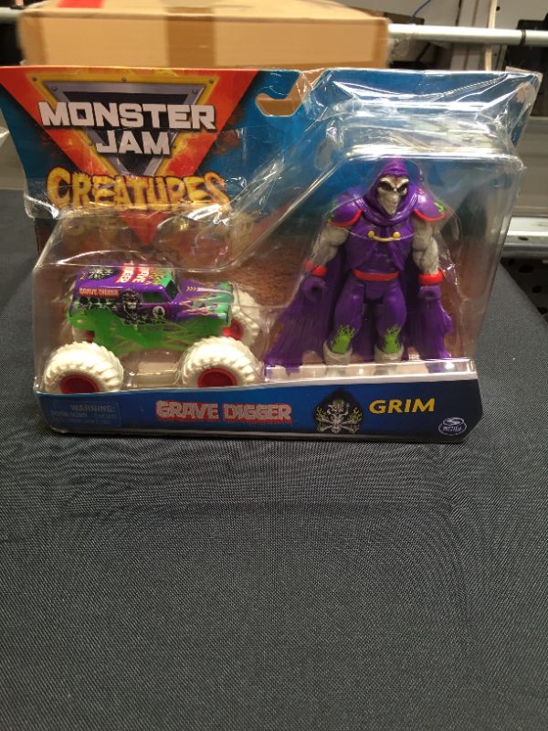 Photo 2 of Monster Jam, Official Grave Digger 1:64 Scale Monster Truck and 5-Inch Grim Creatures Action Figure Set
