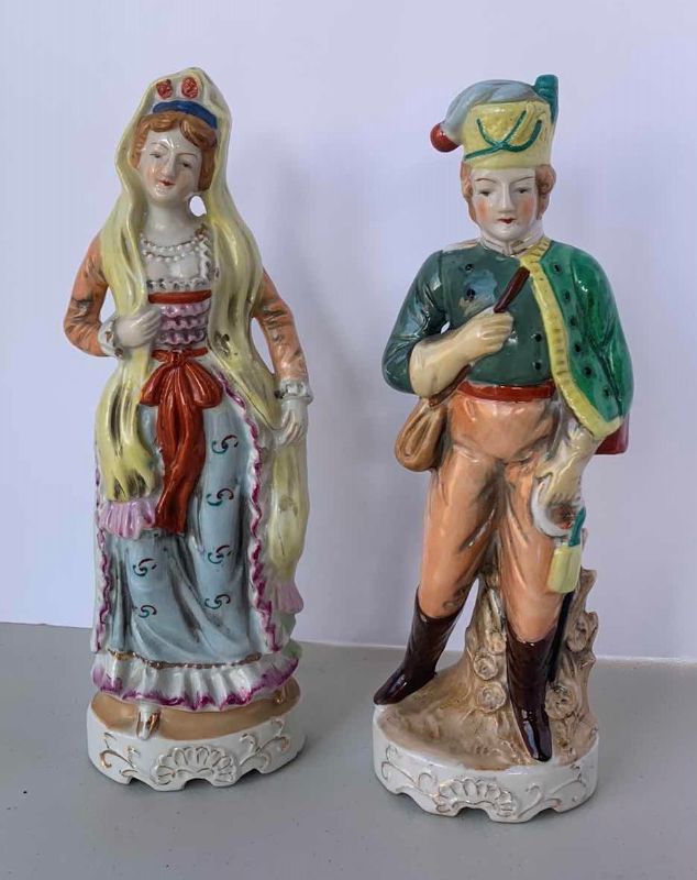 Photo 1 of TWO 10” HANDPAINTED 
PORCELAIN FIGURINES