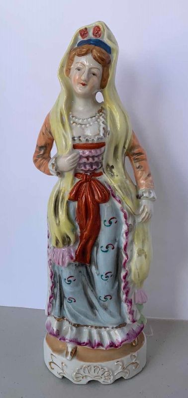 Photo 2 of TWO 10” HANDPAINTED 
PORCELAIN FIGURINES