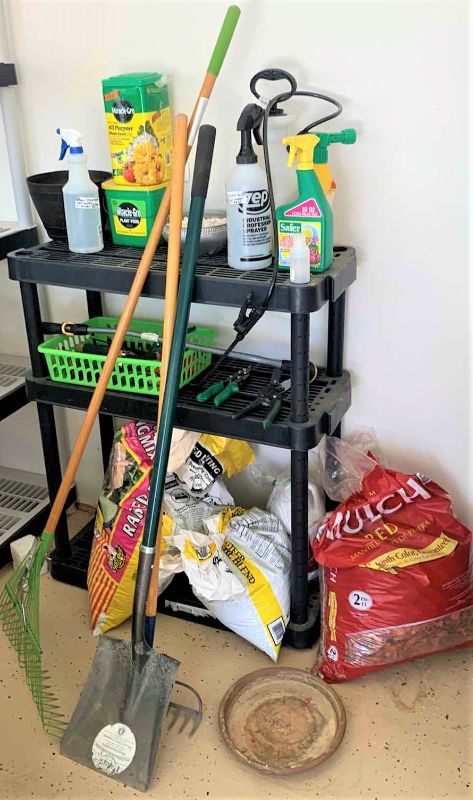 Photo 1 of BLACK SHELF UNIT AND GARDENING SUPPLIES