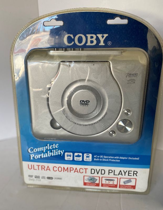 Photo 2 of COBY ULTRA COMPACT DVD PLAYER AND NAXA WIRELESS HEADPHONE SYSTEM