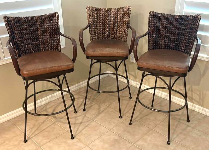 Photo 1 of 3-METAL AND RATTAN WOVEN SWIVEL BAR STOOLS W LEATHER SEATS,
SEAT HEIGHT 30", OVERALL HEIGHT 44"