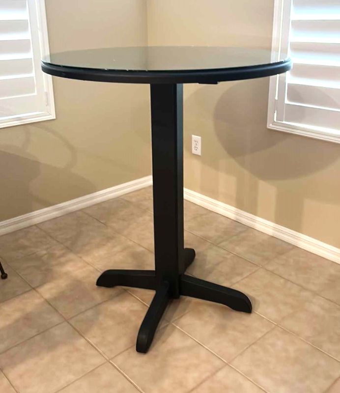 Photo 1 of BLACK PUB TABLE WITH GLASS TOP 36" H 42"