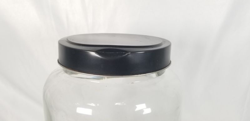 Photo 4 of CLEAR THICK GLASS JAR WITH BLACK METAL LID USED 