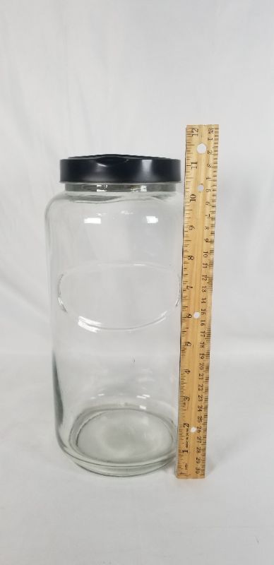 Photo 2 of CLEAR THICK GLASS JAR WITH BLACK METAL LID USED 