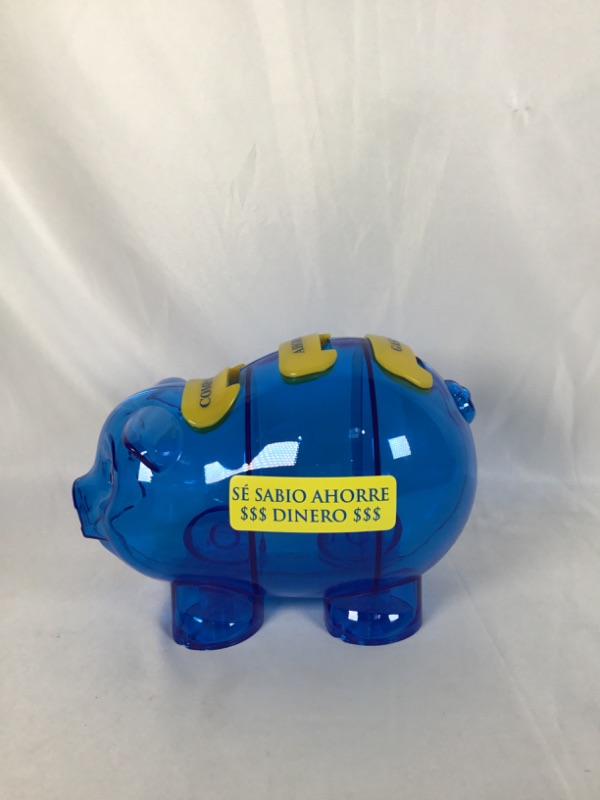 Photo 1 of PLASTIC BLUE PIGGY BANK WITH SPANISH WORDS 5 X 8 X 5.5H INCHES NEW 