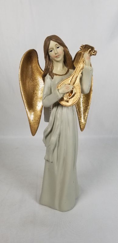 Photo 1 of NEUTRAL TONE DRESS RESIN ANGLE WITH GOLD WINGS PLAYING A GOLD INSTRUMENT 4.5W X 10H INCHES