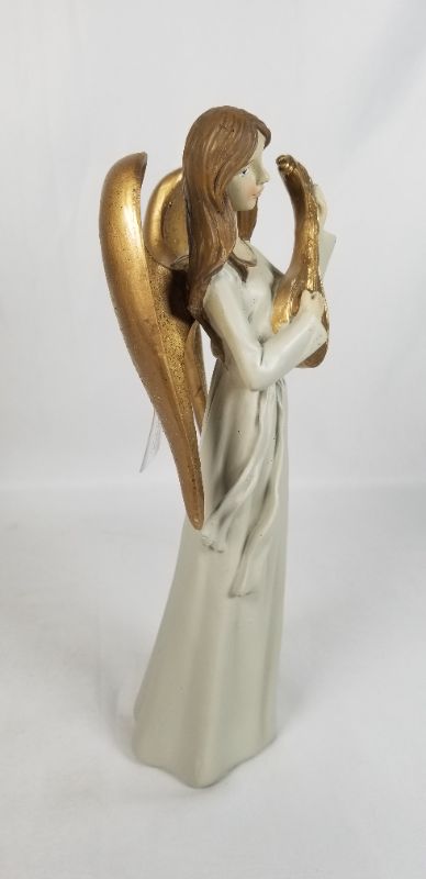 Photo 2 of NEUTRAL TONE DRESS RESIN ANGLE WITH GOLD WINGS PLAYING A GOLD INSTRUMENT 4.5W X 10H INCHES