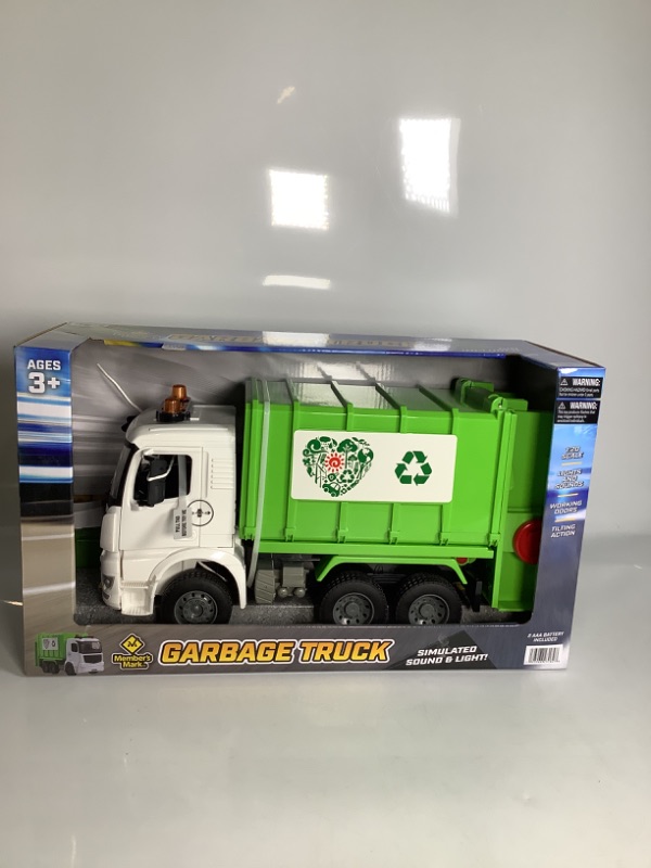 Photo 1 of GARBAGE TRUCK  AGES 3 PLUS SIMULATED SOUND AND LIGHT COLOR GREEN LIGHTS AND SOUNDS, WORKING DOORS, TILTING ACTION NEW