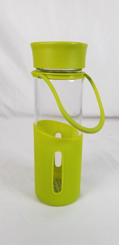 Photo 2 of CLEAR GLASS WATER BOTTLE WITH GREEN SILICONE BOTTOM AND PLASTIC TOP 2.5D X 8.5H INCHES NEW